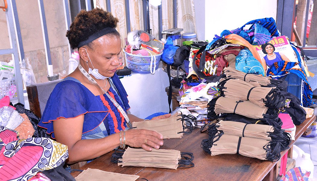 Eugenie Kabeya counts the masks she's made after pivoting her business after the pandemic