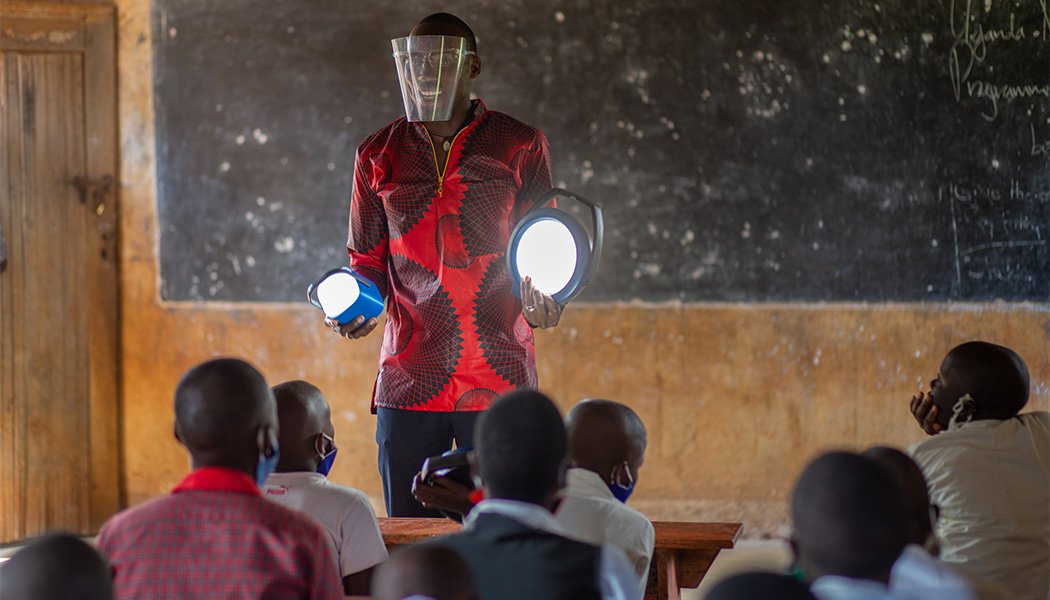 A School Staff Member Smiles About the New Solar Lamps