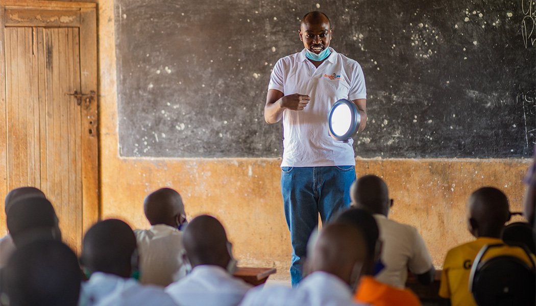 Nelson Mugisha Demonstrating a Solar Lamp