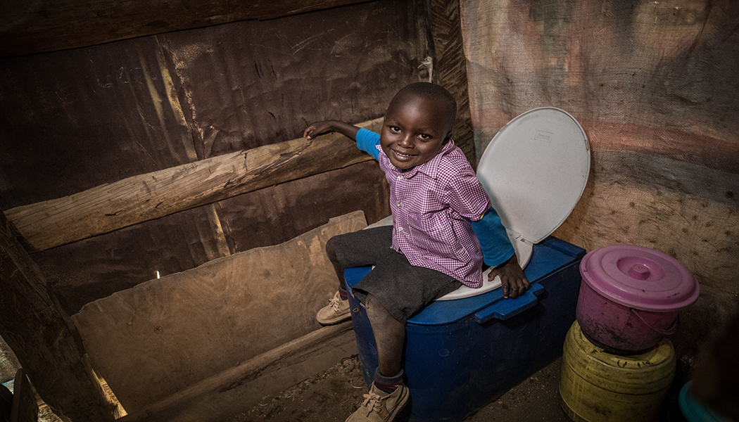 Rural-Women-Kenya-Sanivation-Blue-Box-Toilet-Child