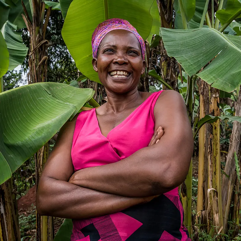 Prossy Nanyonga smiles because of the female empowerment she received from FINCA